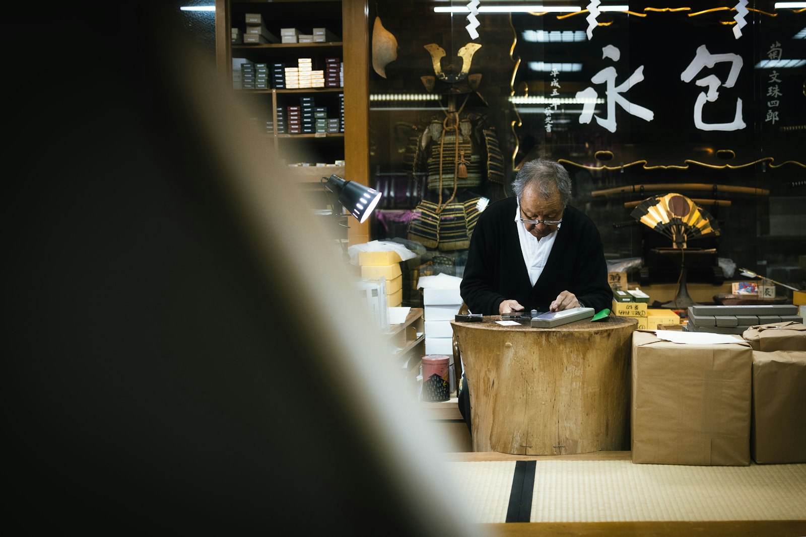 Small business owner behind the counter of their shop
